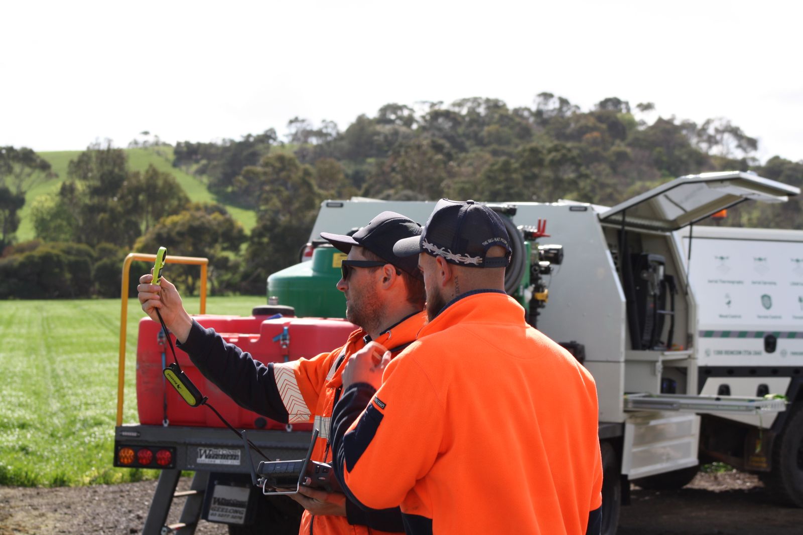 Pilots operating a DJI AGRAS spray drone